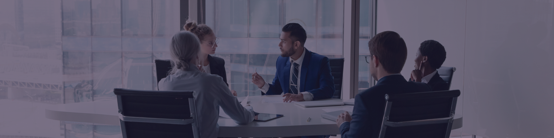 Group of business people sat around table discussing plans